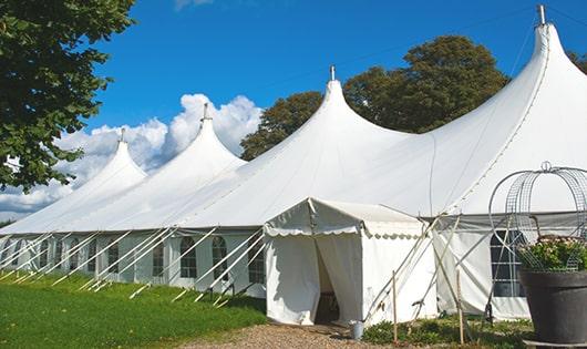 a row of blue portable restrooms waiting to be used at a event in Campbell Hall, NY